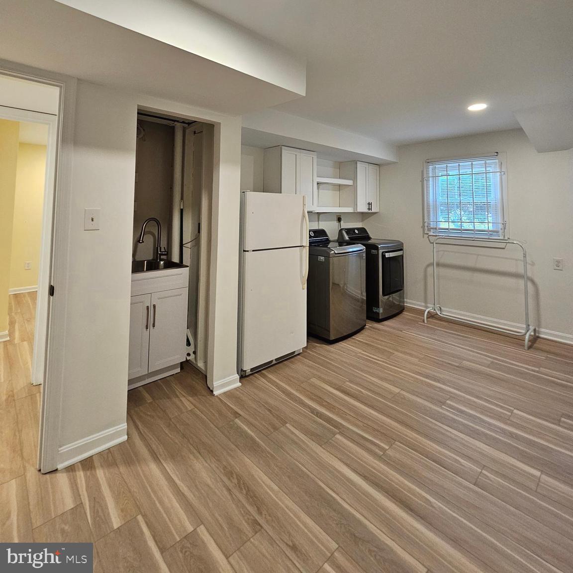 7777 Turlock Road Springfield, VA 22153 - Photo 30 of 43 a view of a kitchen with a refrigerator a stove top oven and cabinets