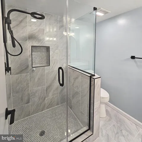 a bathroom with a glass shower door