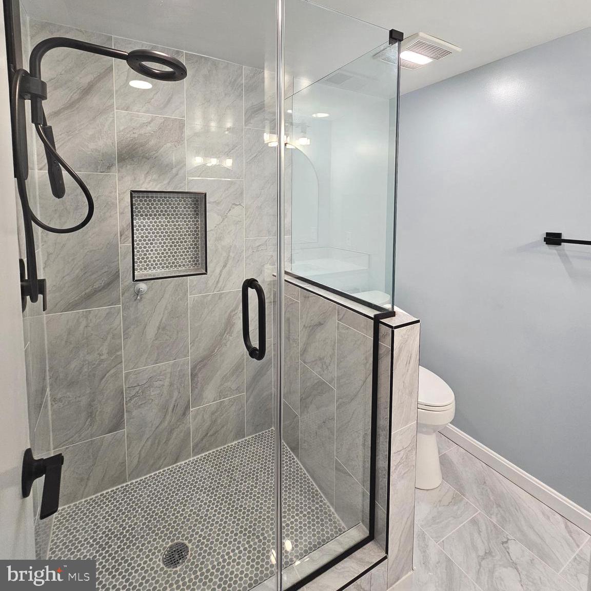 7777 Turlock Road Springfield, VA 22153 - Photo 32 of 43 a bathroom with a glass shower door