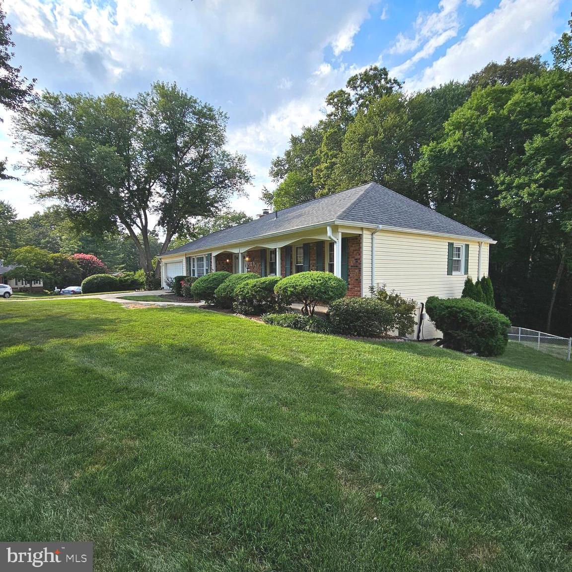 7777 Turlock Road Springfield, VA 22153 - Photo 38 of 43 a front view of a house with a yard and trees