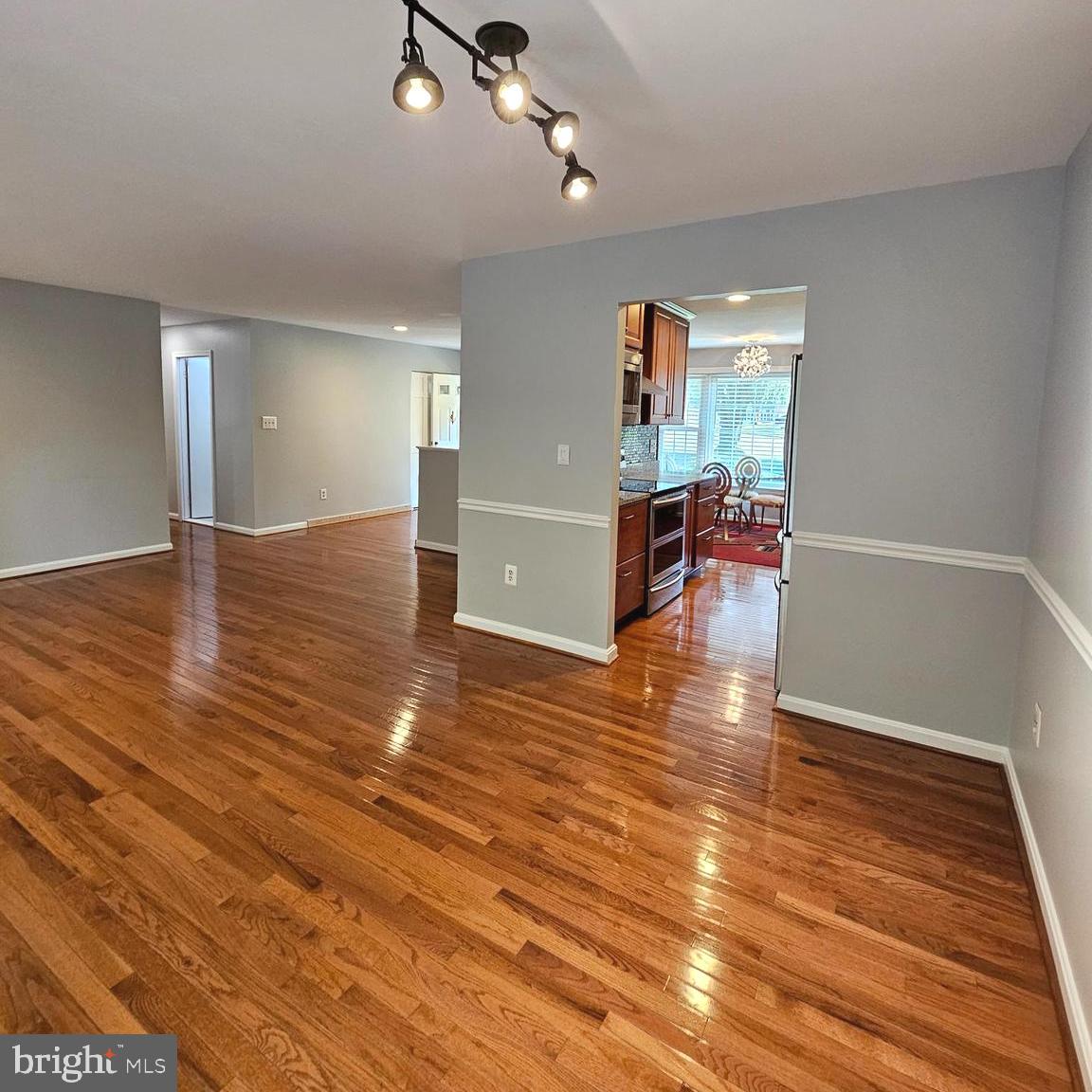 7777 Turlock Road Springfield, VA 22153 - Photo 7 of 43 wooden floor in an empty room with a window