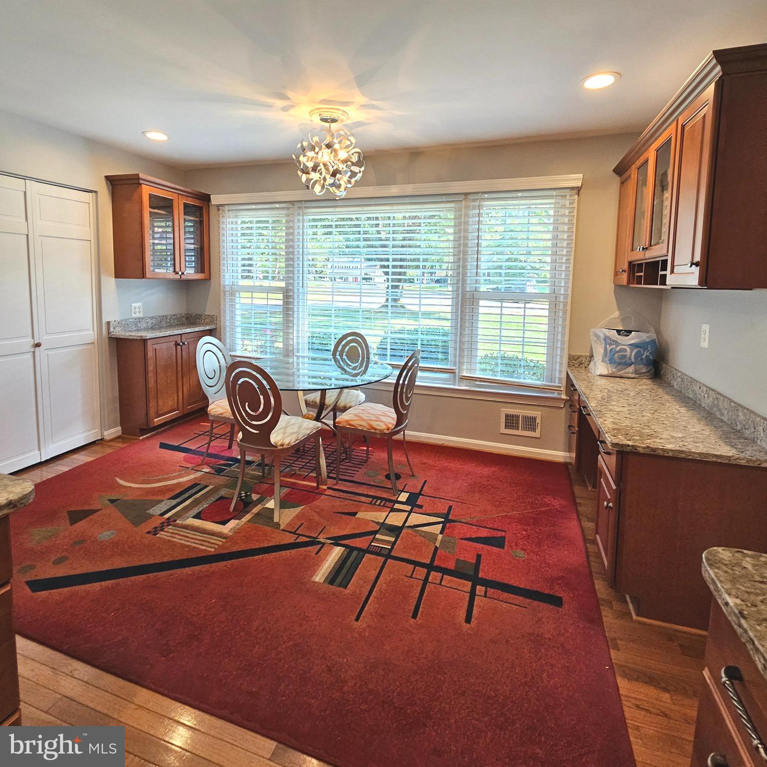 7777 Turlock Road Springfield, VA 22153 - Photo 9 of 43 a dining room with furniture a rug and wooden floor