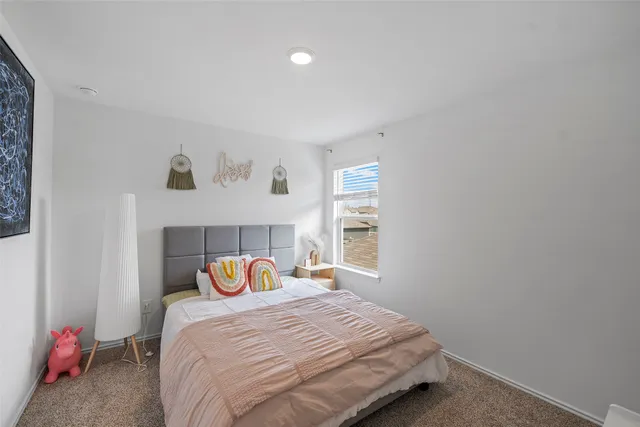 a bedroom with furniture and a window