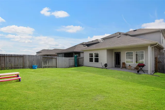 a view of a two chairs and table in backyard