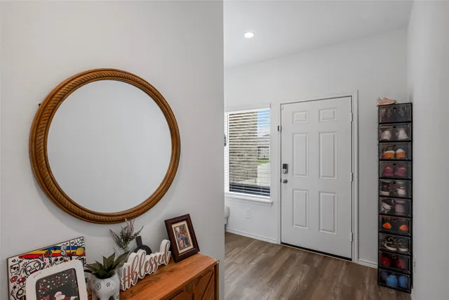 an entryway with a workspace and a mirror