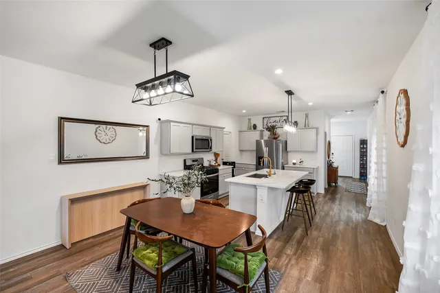a very nice looking dining room with a table and chairs