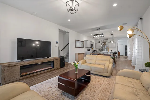 a view of a dining room with furniture wooden floor and a chandelier