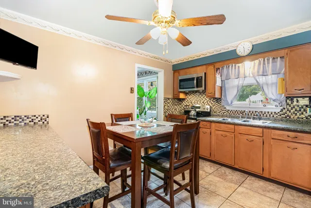 a kitchen with a table chairs sink and microwave