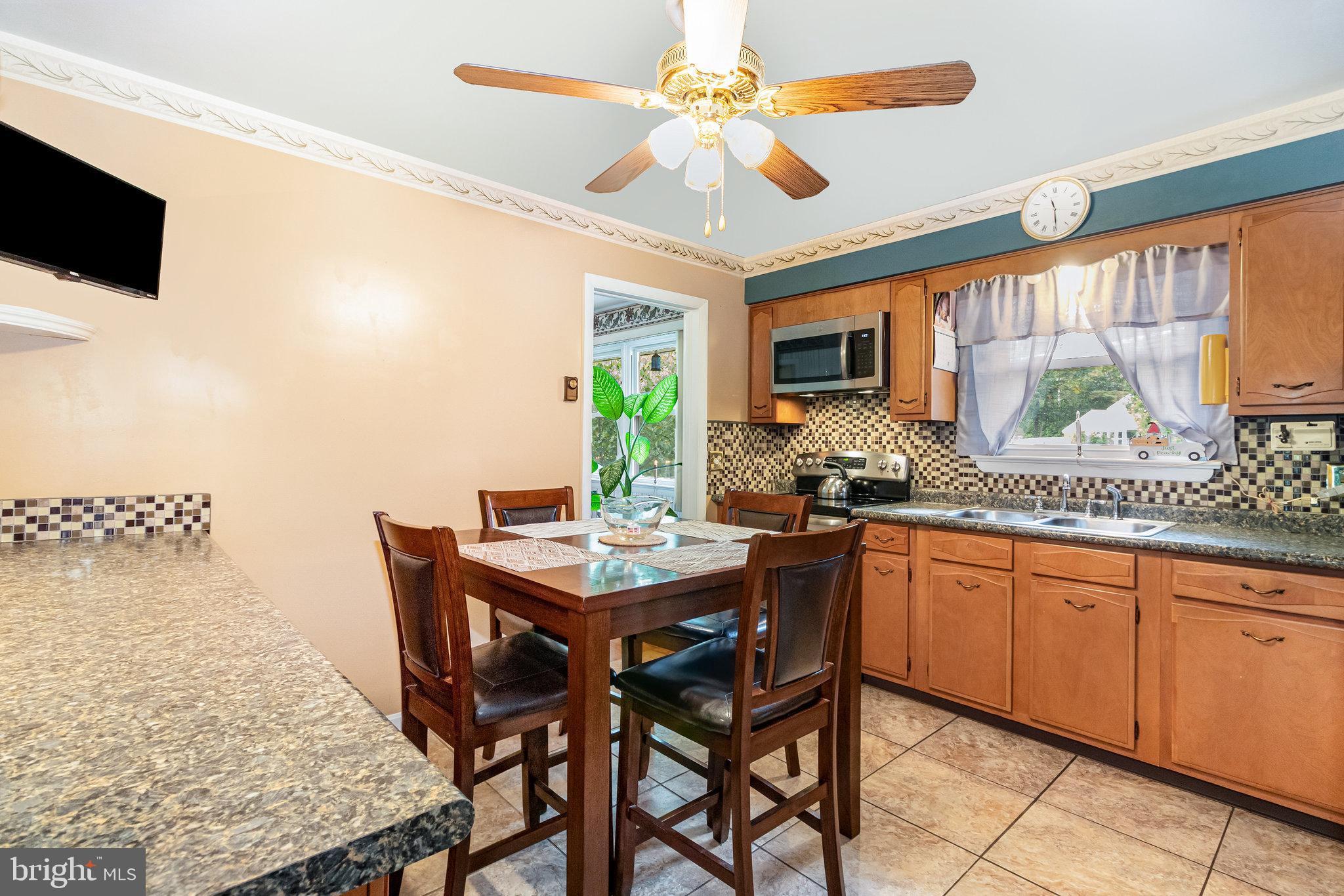 414 Trudy Road Harrisburg, PA 17109 - Photo 6 of 26 a kitchen with a table chairs sink and microwave