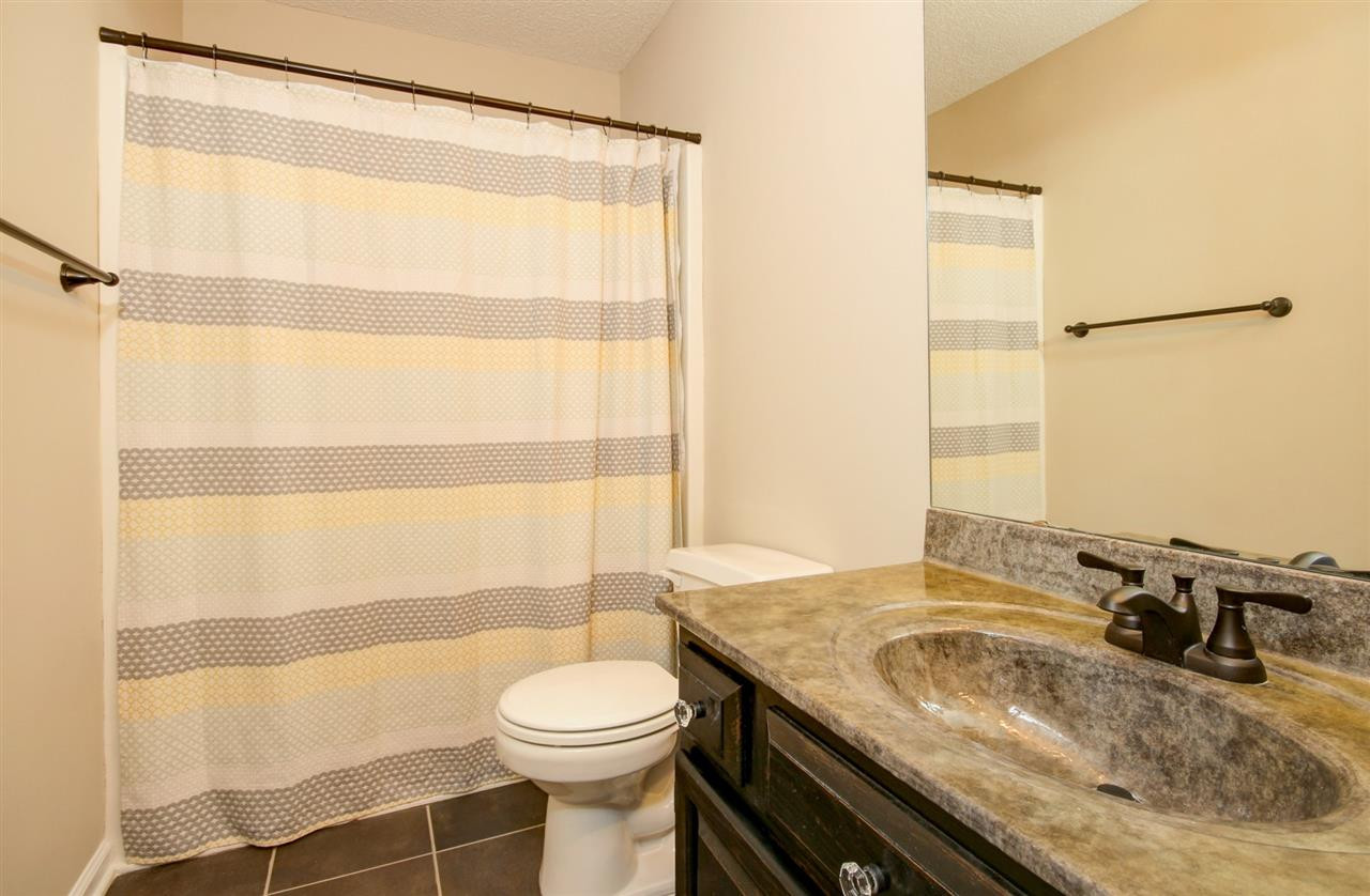 4402 Still Pines Drive Raleigh, NC 27613 - Photo 17 of 25 Upstairs full bath where the tile floors and granite continue. There's an additional powder room on the 1st floor for guests. Bathroom