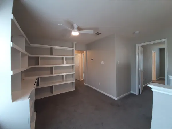 a view of an empty room with a closet