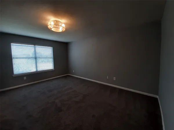 an empty room with a empty space and windows