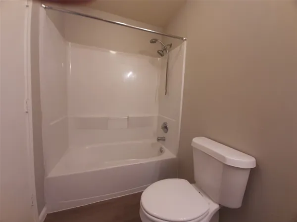 a white toilet and tub sitting next to a bathroom sink