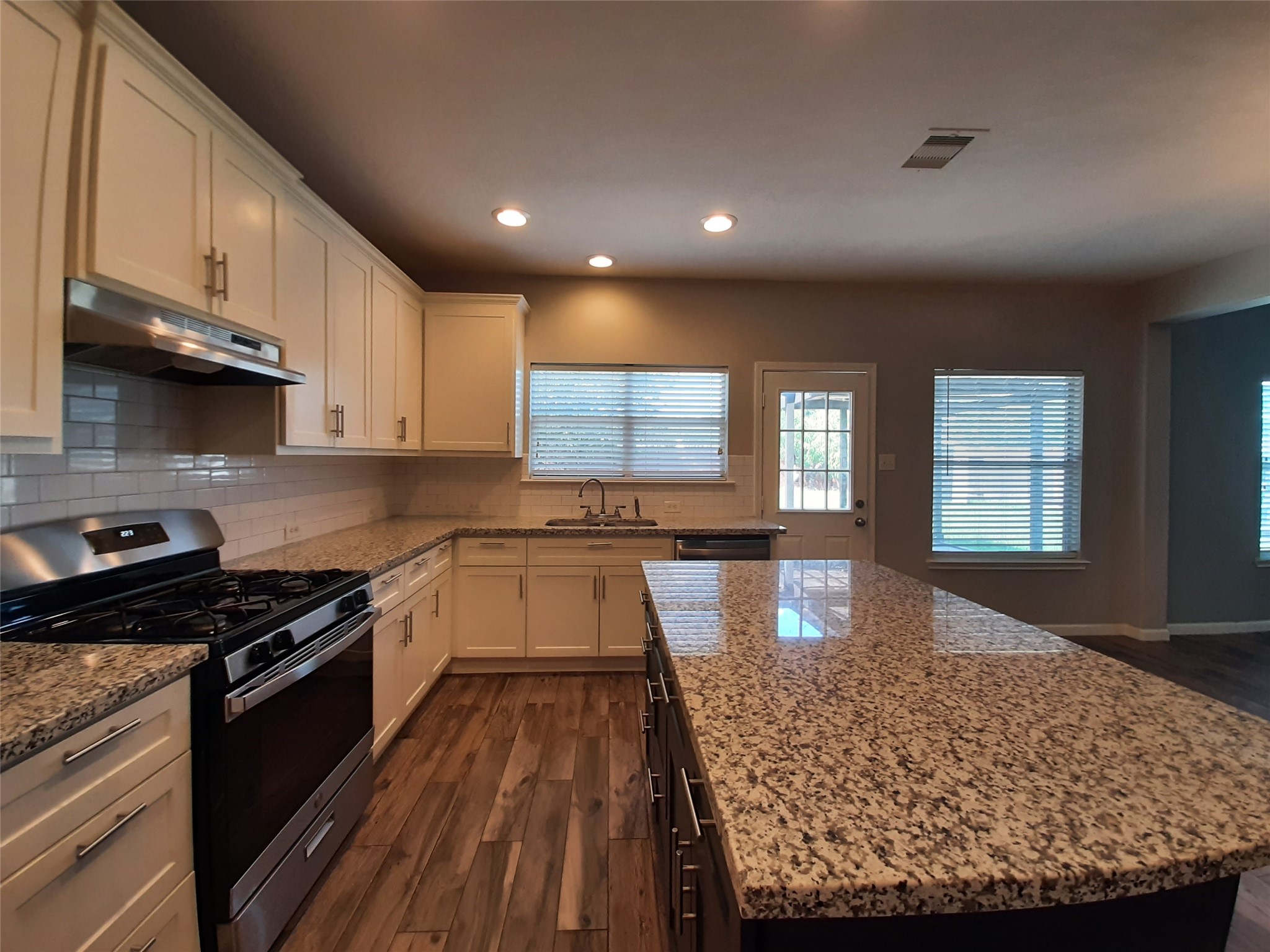 20526 Rustic Rail Court Cypress, TX 77433 - Photo 9 of 23 a large kitchen with stainless steel appliances granite countertop a stove a sink and a granite counter tops