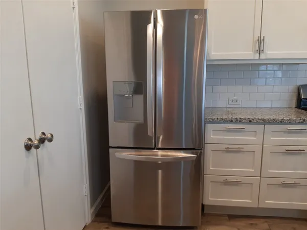 a view of a refrigerator in kitchen