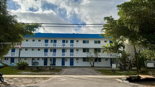 a front view of a residential apartment building with a yard