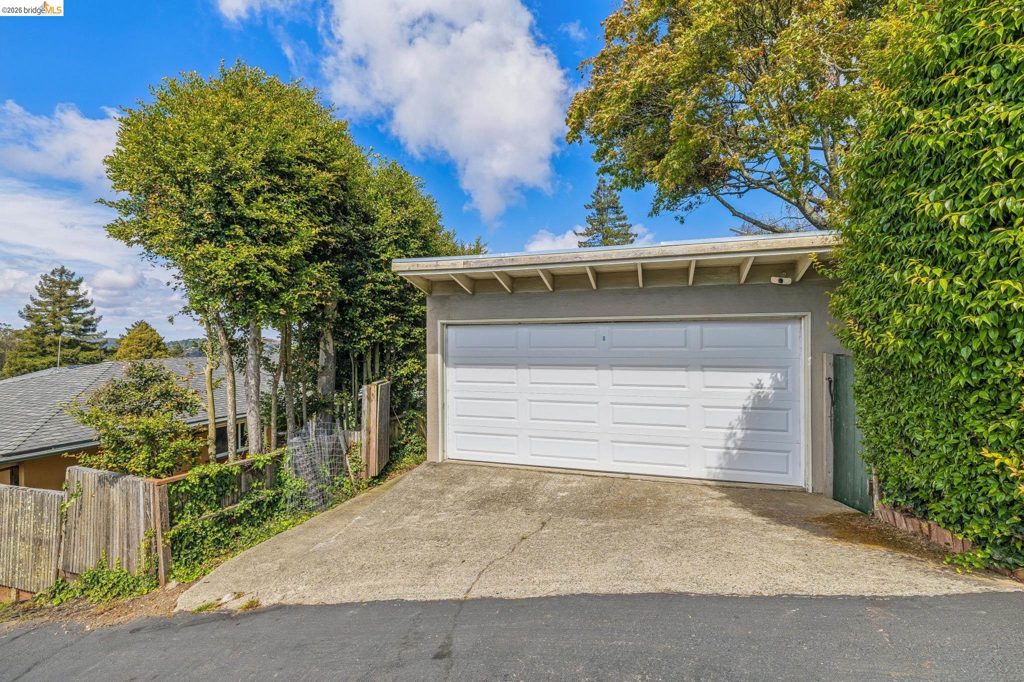 1024 Overlook Road Berkeley, CA 94708 - Photo 41 of 41 Attached garage with a white panel door and concrete driveway