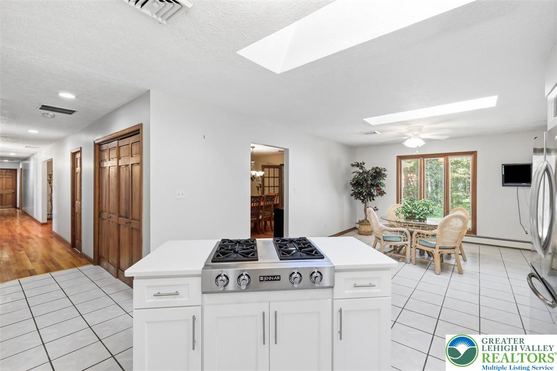 123 Meadow Road Blakeslee, PA 18610 - Photo 22 of 53 Natural light pours through dual skylights in this open kitchen featuring a central island.