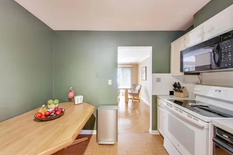 a kitchen with a stove and cabinets