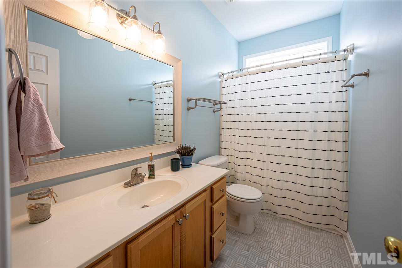 4425 Gallatree Lane Raleigh, NC 27616 - Photo 20 of 24 Tile flooring, transom window for extra light, and updated fixtures.