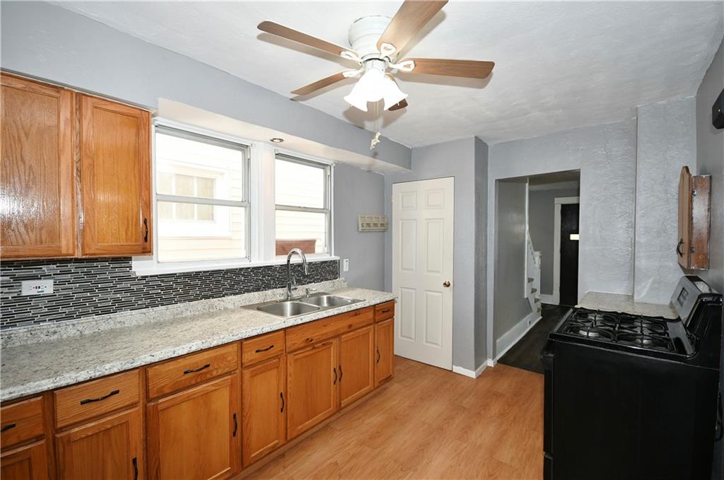 335 Mercer Street Turtle Creek, PA 15145 - Photo 11 of 25 a kitchen with a refrigerator and a sink