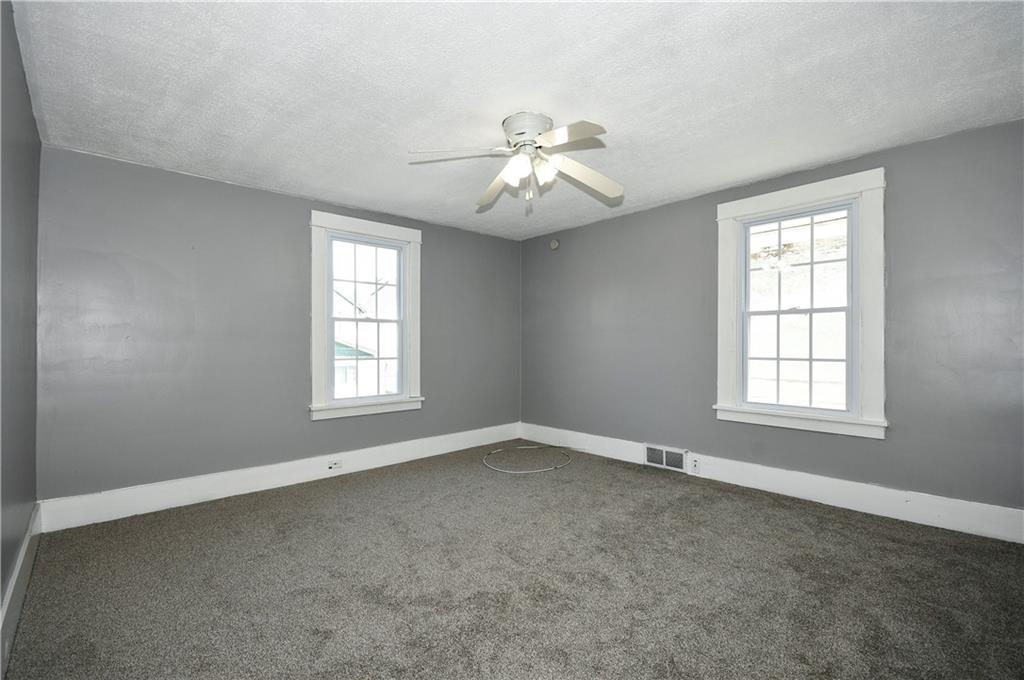 335 Mercer Street Turtle Creek, PA 15145 - Photo 14 of 25 an empty room with windows and fan