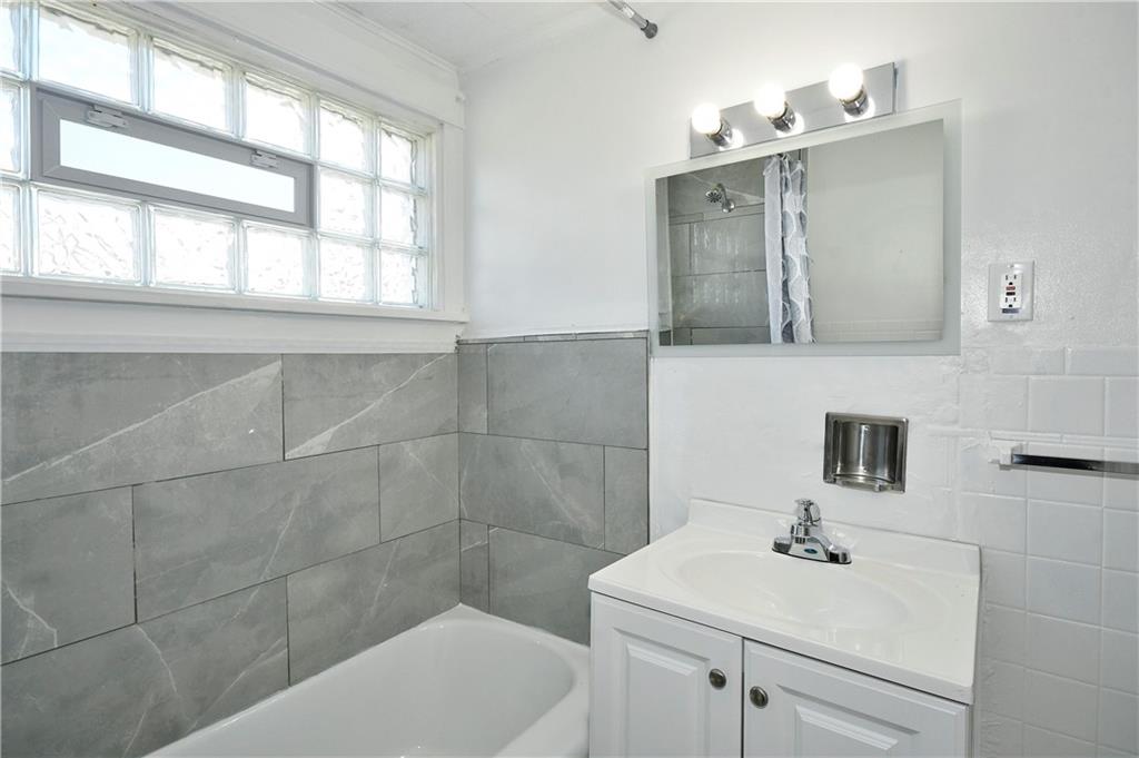 335 Mercer Street Turtle Creek, PA 15145 - Photo 17 of 25 a bathroom with a sink a toilet and mirror