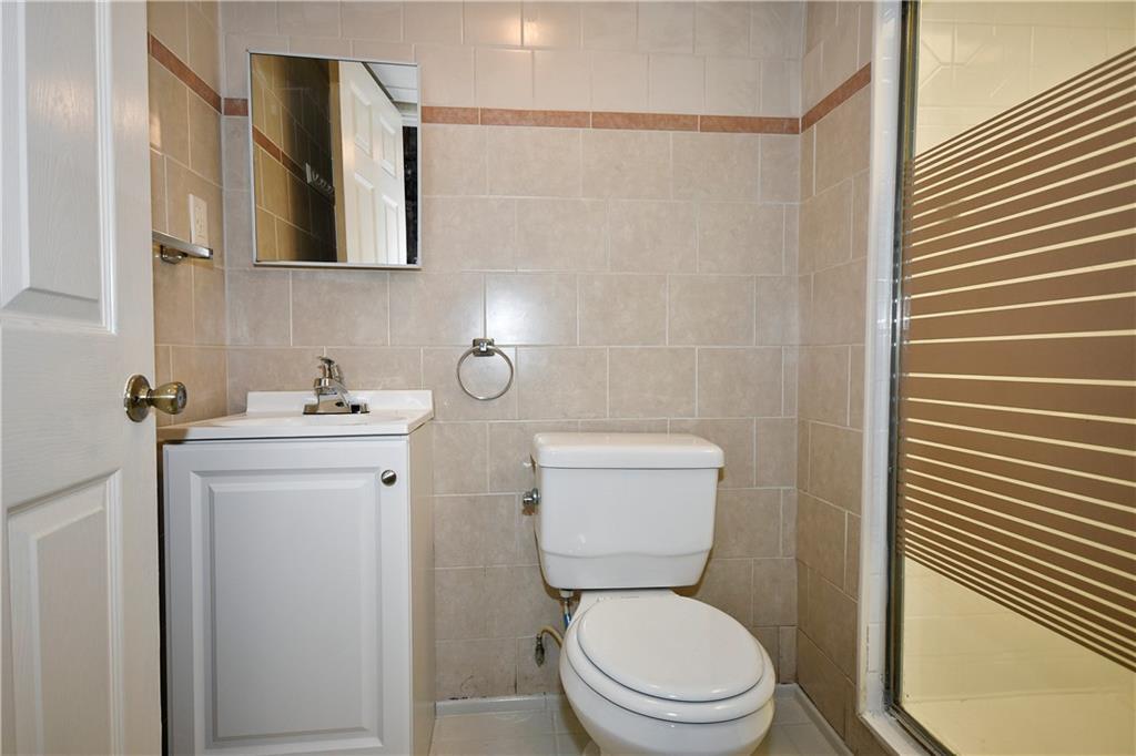 335 Mercer Street Turtle Creek, PA 15145 - Photo 19 of 25 a white toilet sitting next to a bathroom sink