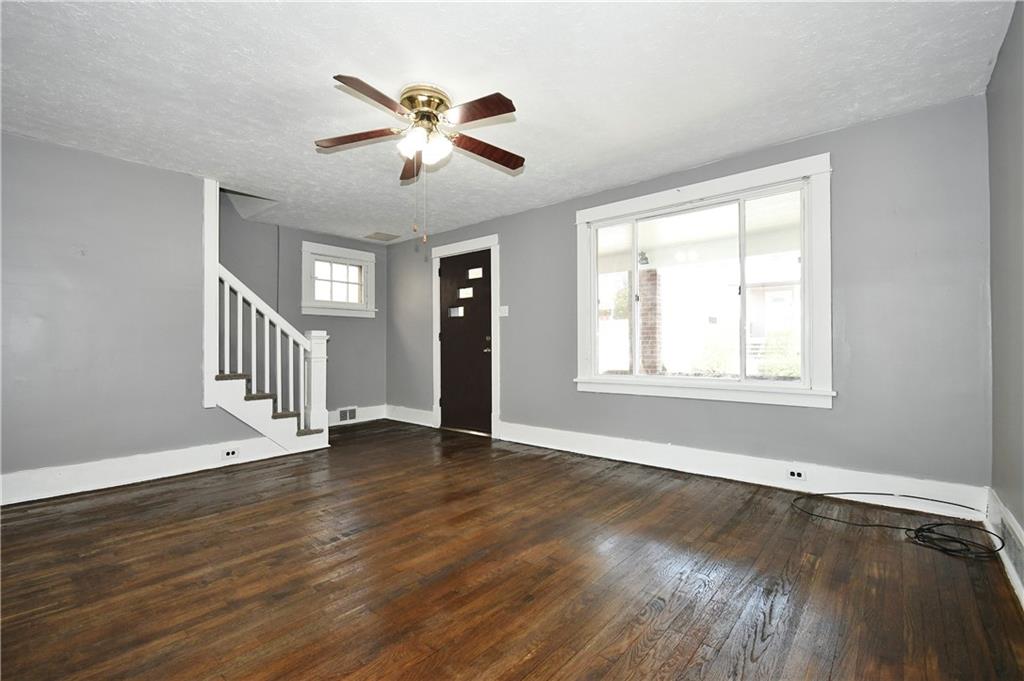 335 Mercer Street Turtle Creek, PA 15145 - Photo 4 of 25 a view of an empty room with wooden floor and a window