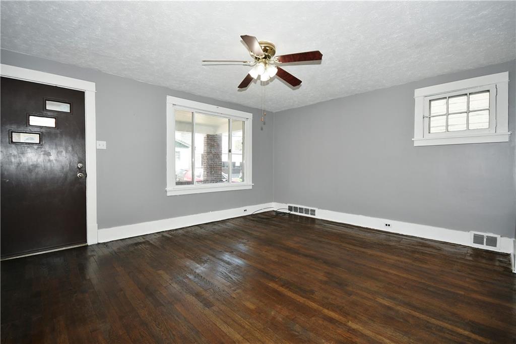 335 Mercer Street Turtle Creek, PA 15145 - Photo 5 of 25 a view of an empty room with wooden floor and a window