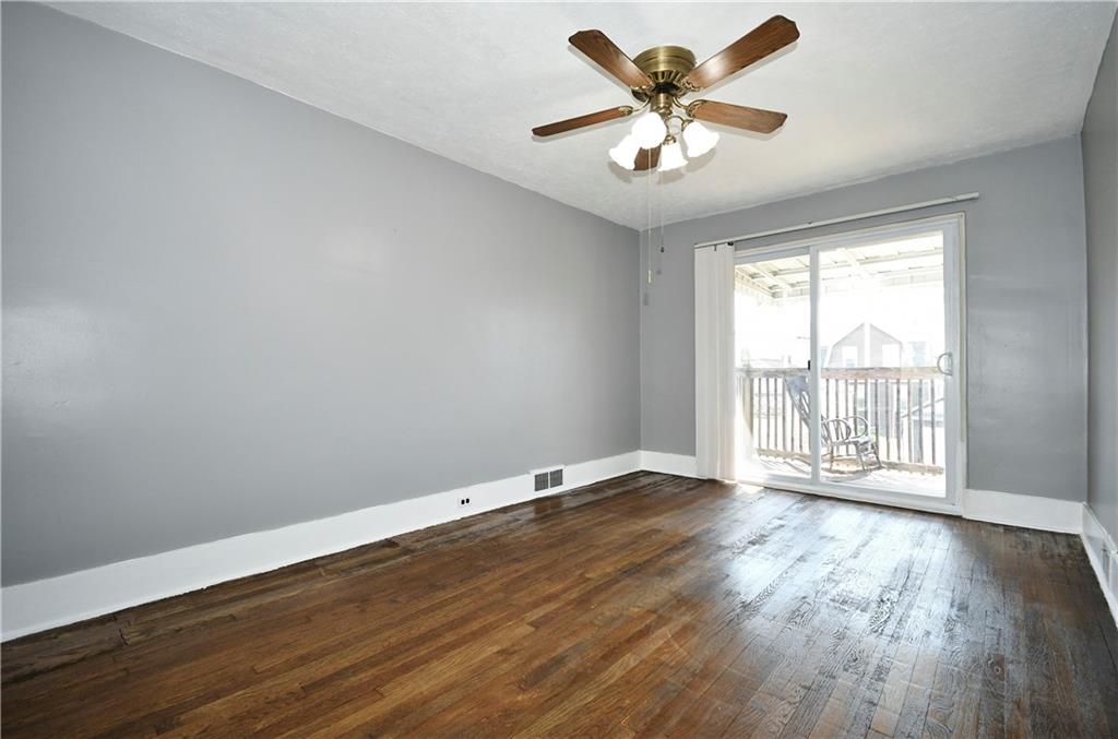 335 Mercer Street Turtle Creek, PA 15145 - Photo 6 of 25 an empty room with wooden floor and windows