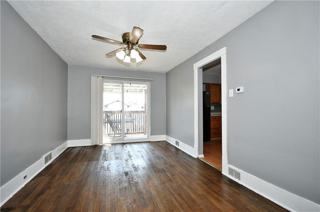 335 Mercer Street Turtle Creek, PA 15145 - Photo 7 of 25 a view of an empty room with wooden floor and a window
