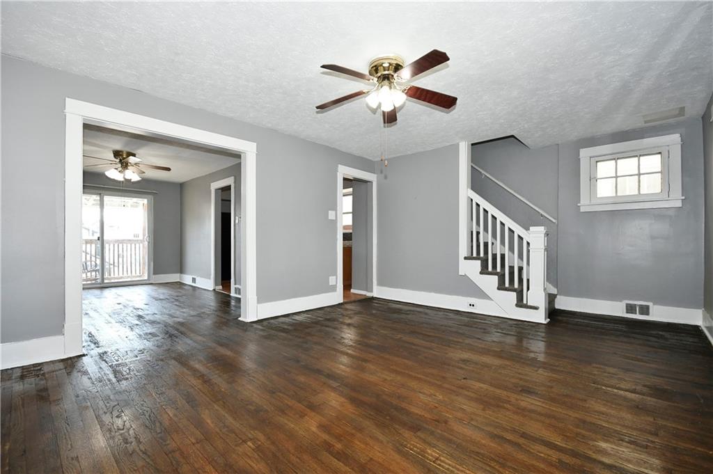335 Mercer Street Turtle Creek, PA 15145 - Photo 9 of 25 a view of an empty room with wooden floor and a window