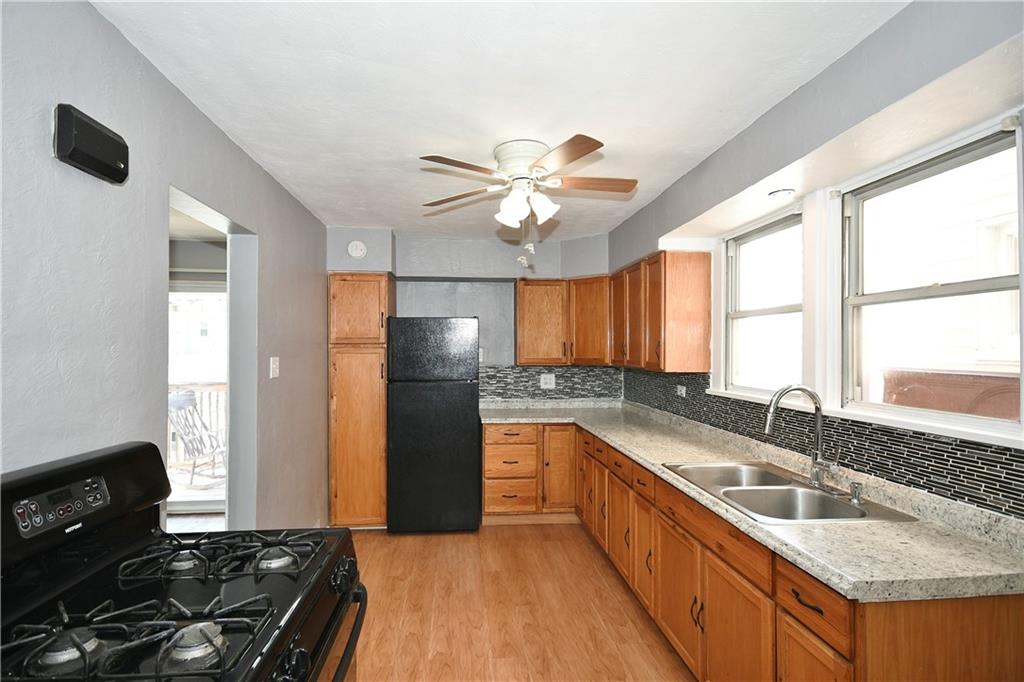 335 Mercer Street Turtle Creek, PA 15145 - Photo 10 of 25 a kitchen with stainless steel appliances granite countertop a sink stove and refrigerator
