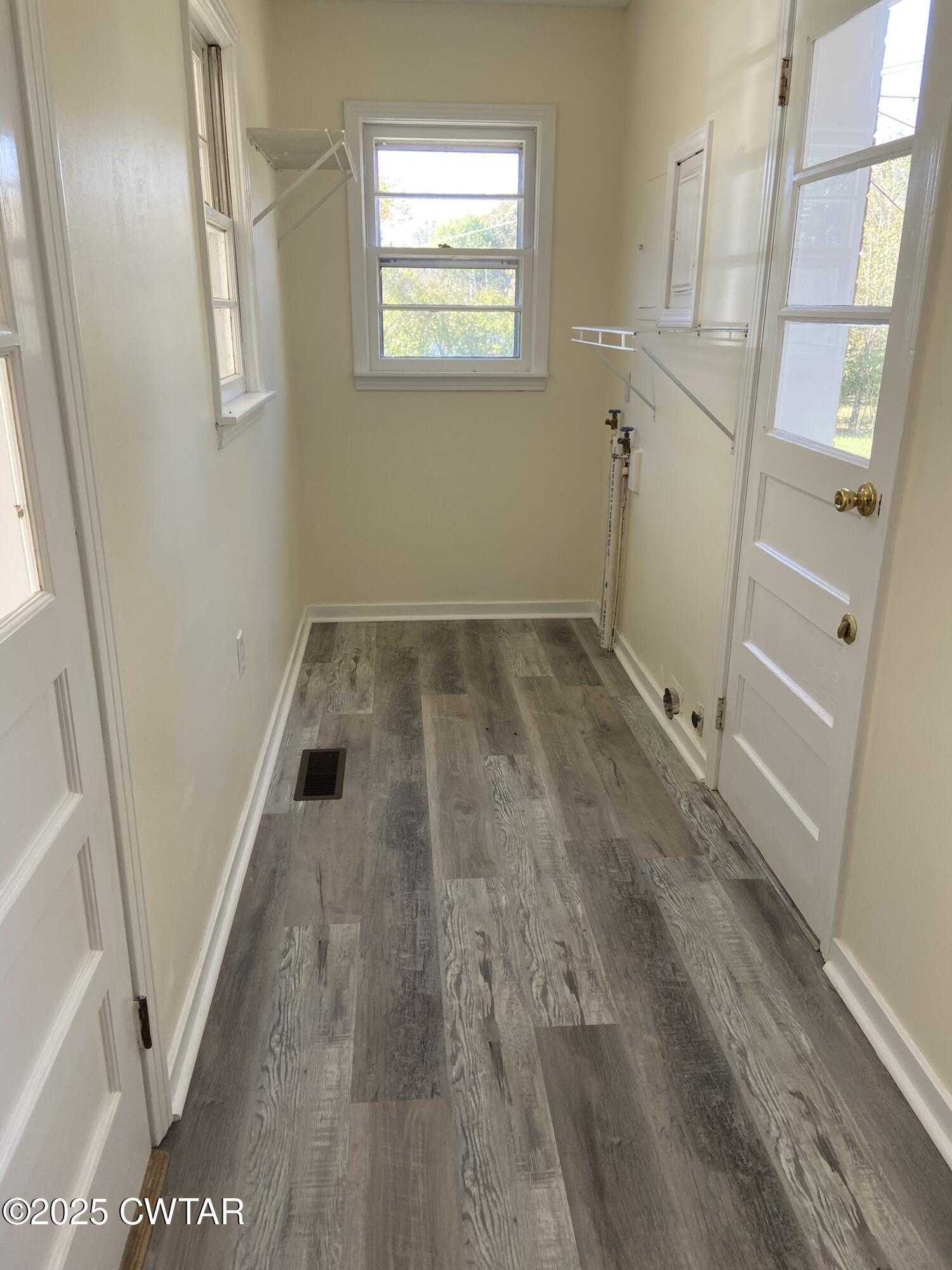 437 East 2nd Street Henderson, TN 38340 - Photo 2 of 16 a view of an empty room with wooden floor