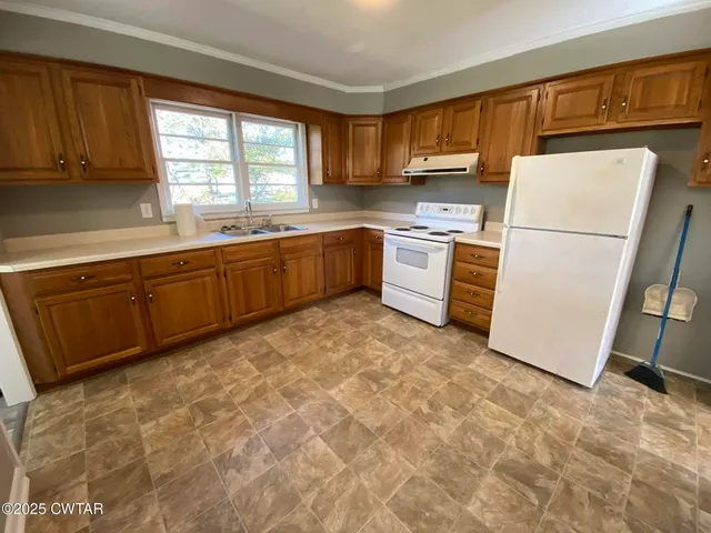 a kitchen with sink cabinets and window