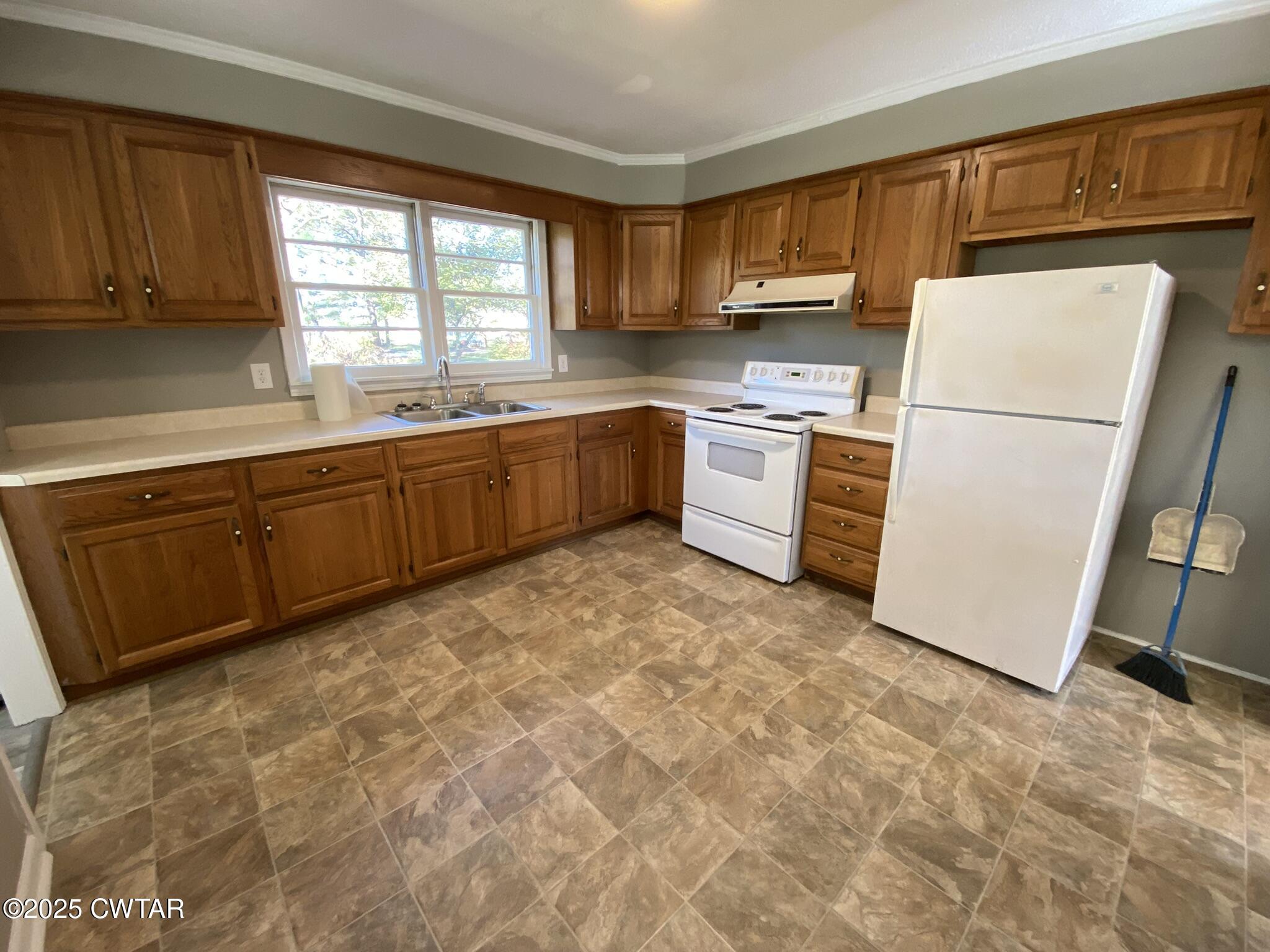 437 East 2nd Street Henderson, TN 38340 - Photo 4 of 16 a kitchen with sink cabinets and window