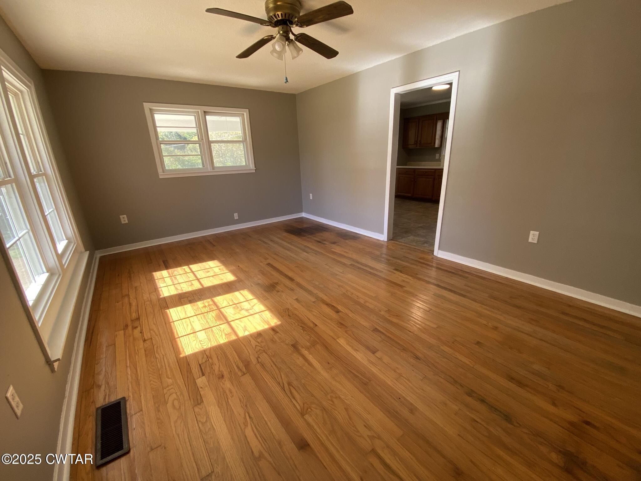 437 East 2nd Street Henderson, TN 38340 - Photo 7 of 16 wooden floor in an empty room with a window