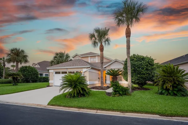 a front view of multiple houses with yard