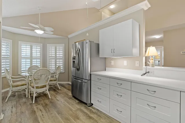 a kitchen with stainless steel appliances kitchen island granite countertop a dining table chairs and granite counter tops