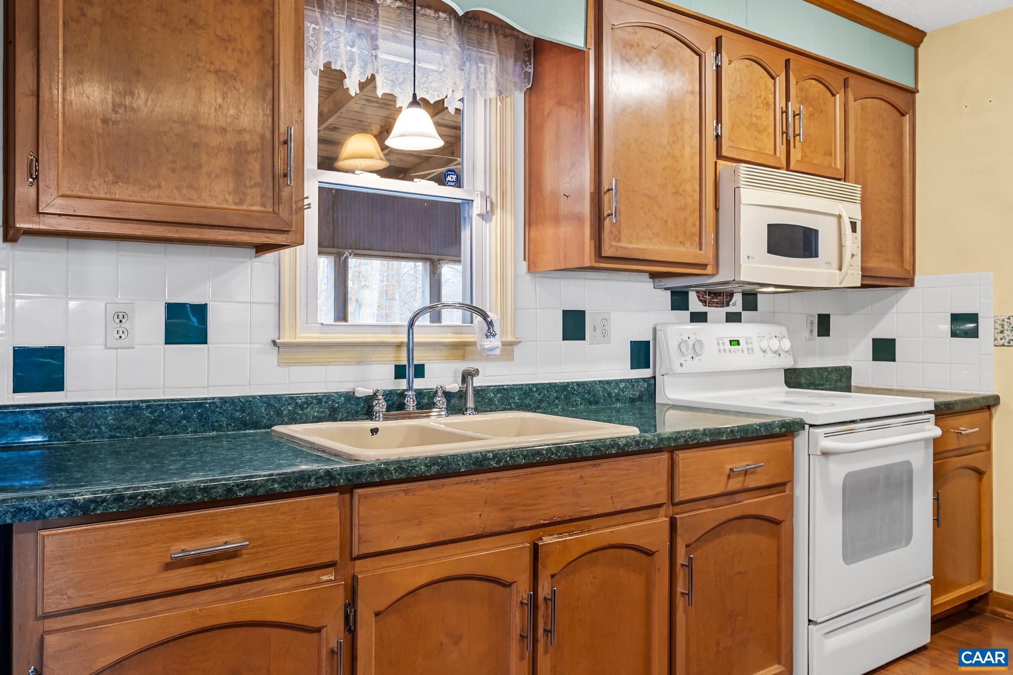 987 Matthew Mill Road Ruckersville, VA 22968 - Photo 10 of 63 a kitchen with granite countertop stainless steel appliances a sink and cabinets