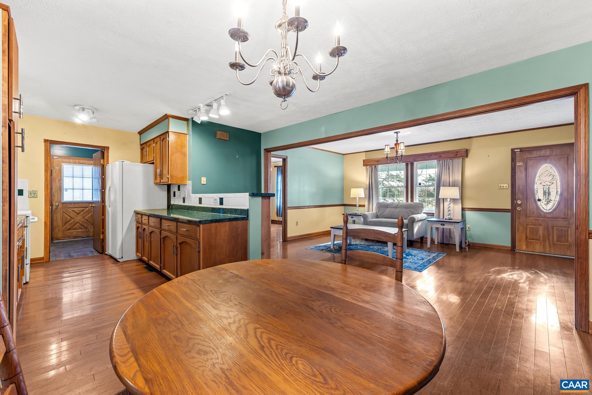 987 Matthew Mill Road Ruckersville, VA 22968 - Photo 14 of 63 a living room with furniture a flat screen tv and a large window