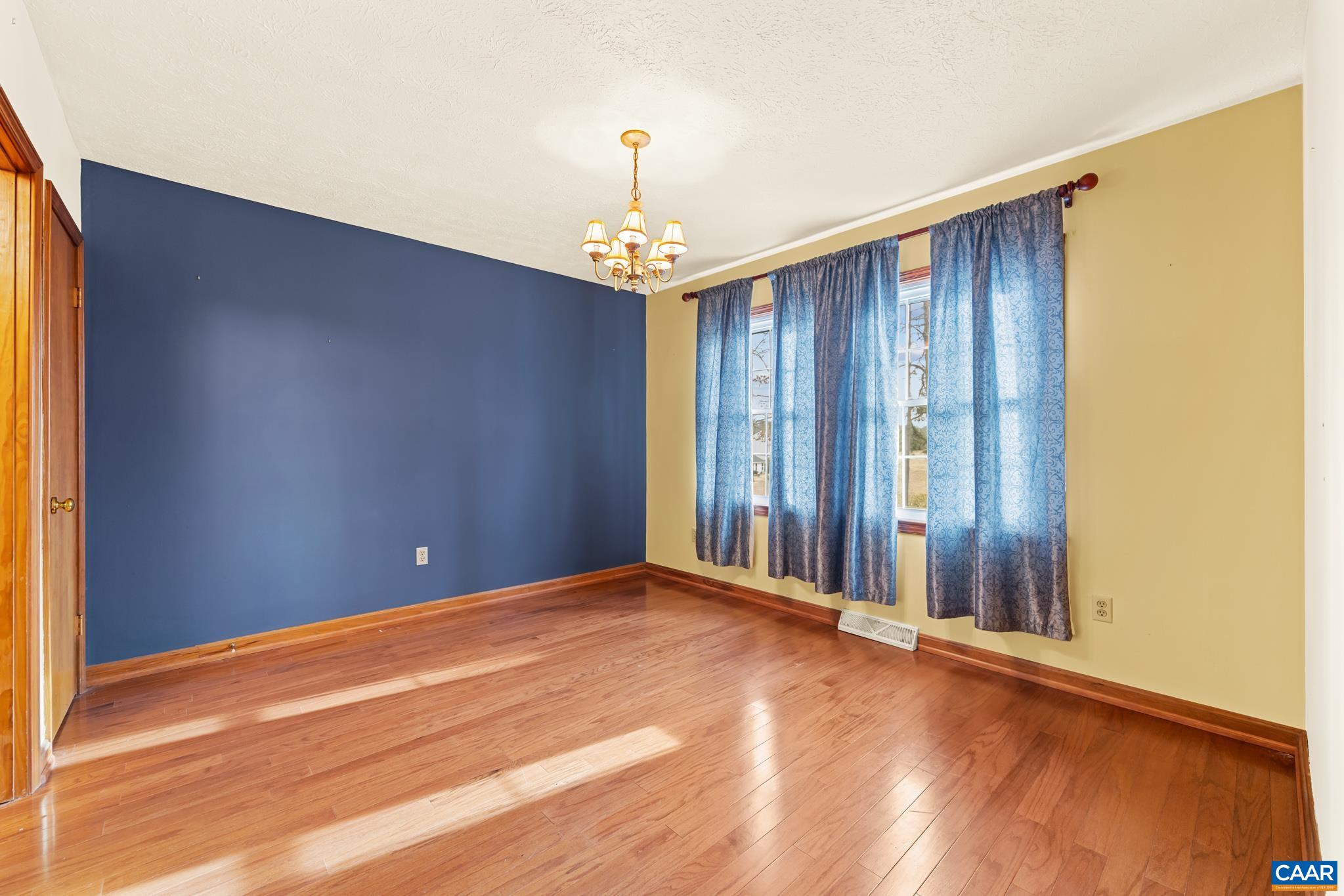 987 Matthew Mill Road Ruckersville, VA 22968 - Photo 17 of 63 a view of a livingroom with an empty space and a window