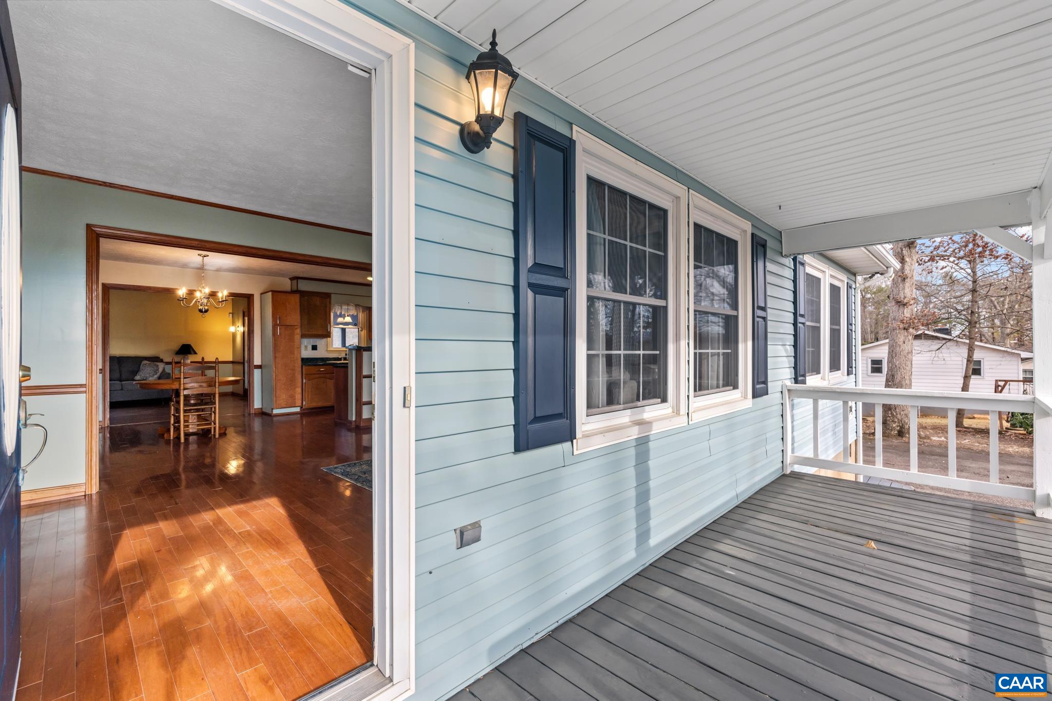 987 Matthew Mill Road Ruckersville, VA 22968 - Photo 61 of 63 Welcome home! Enjoy a bright, open floor plan from the charming covered porch, perfect for relaxing. This light blue home with dark shutters offers a lovely entryway to polished wood floors, leading to a spacious dining & kitchen area.