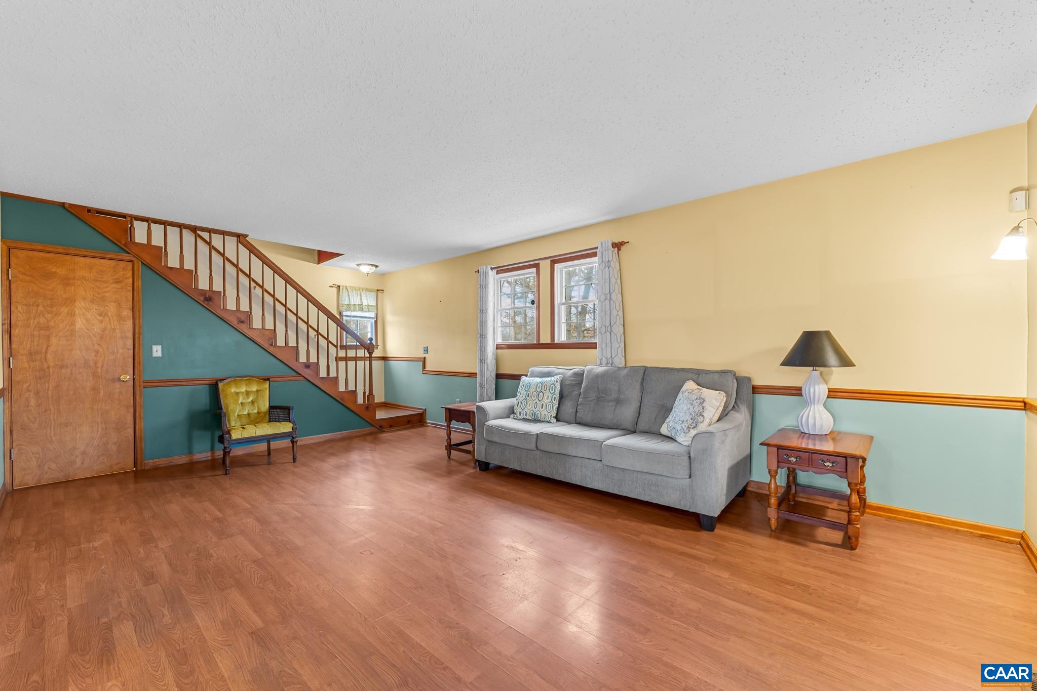 987 Matthew Mill Road Ruckersville, VA 22968 - Photo 25 of 63 a living room with furniture and a wooden floor