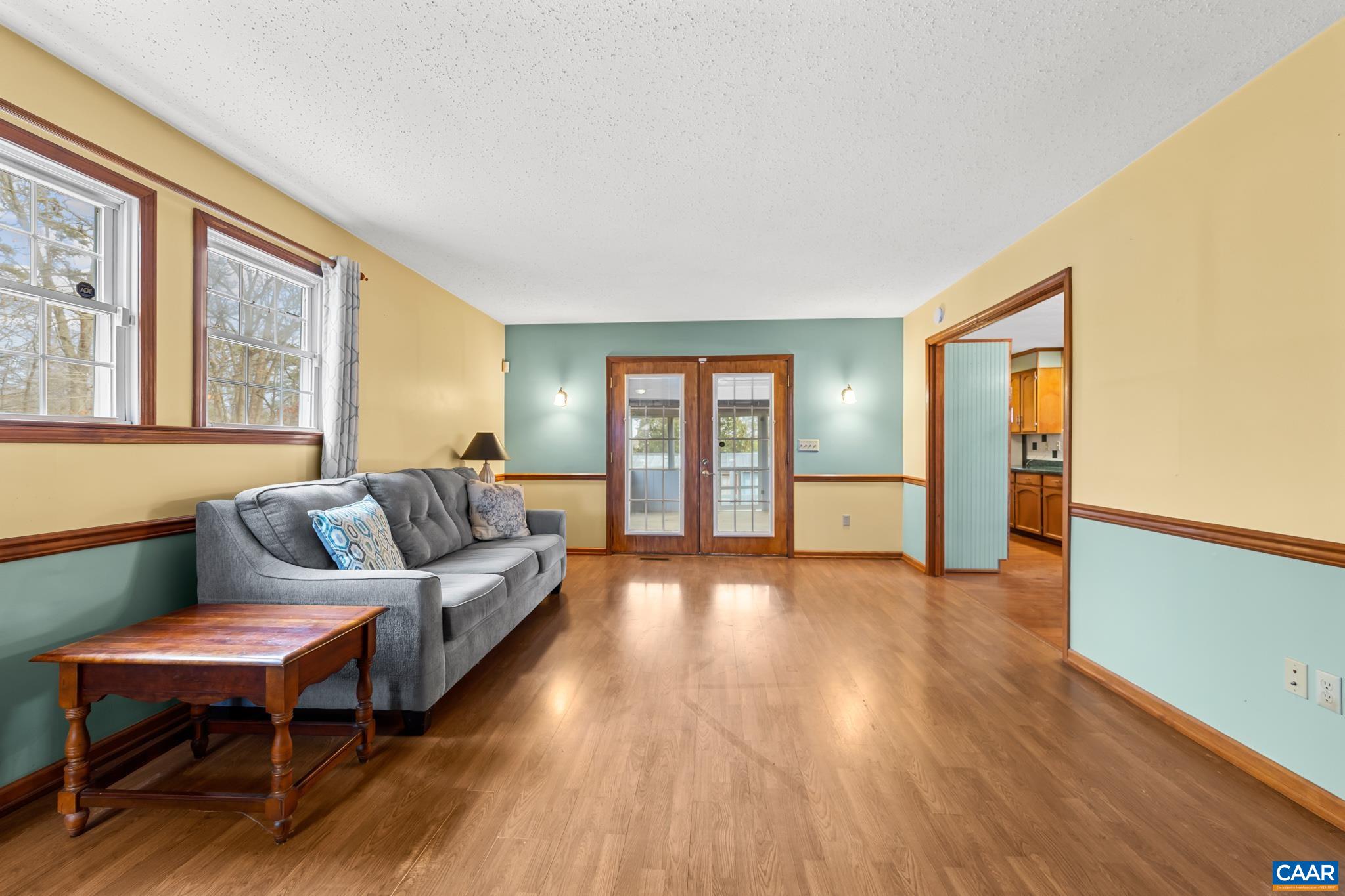 987 Matthew Mill Road Ruckersville, VA 22968 - Photo 27 of 63 a living room with furniture and a wooden floor