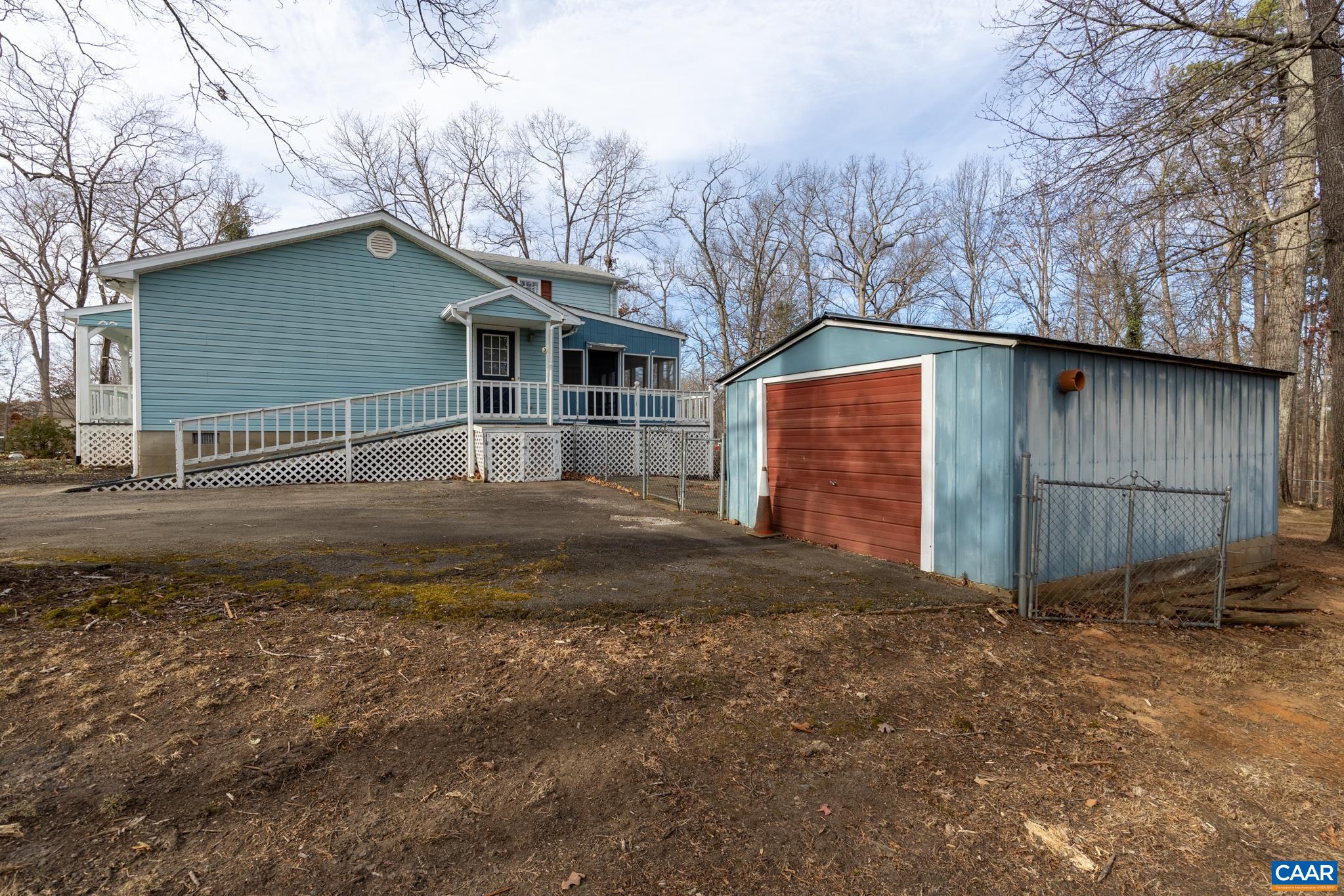 987 Matthew Mill Road Ruckersville, VA 22968 - Photo 51 of 63 a backyard of a house with large trees and wooden fence