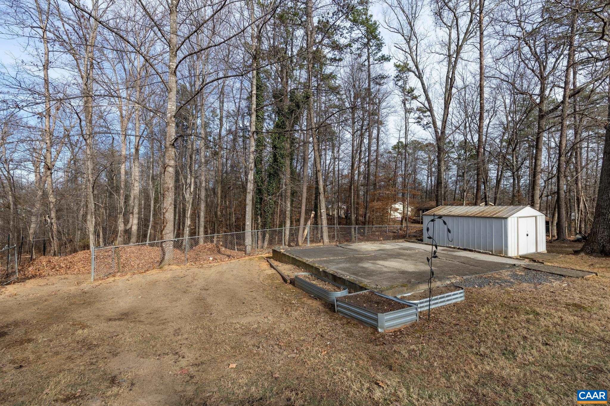 987 Matthew Mill Road Ruckersville, VA 22968 - Photo 52 of 63 a backyard of a house with barbeque oven and trees