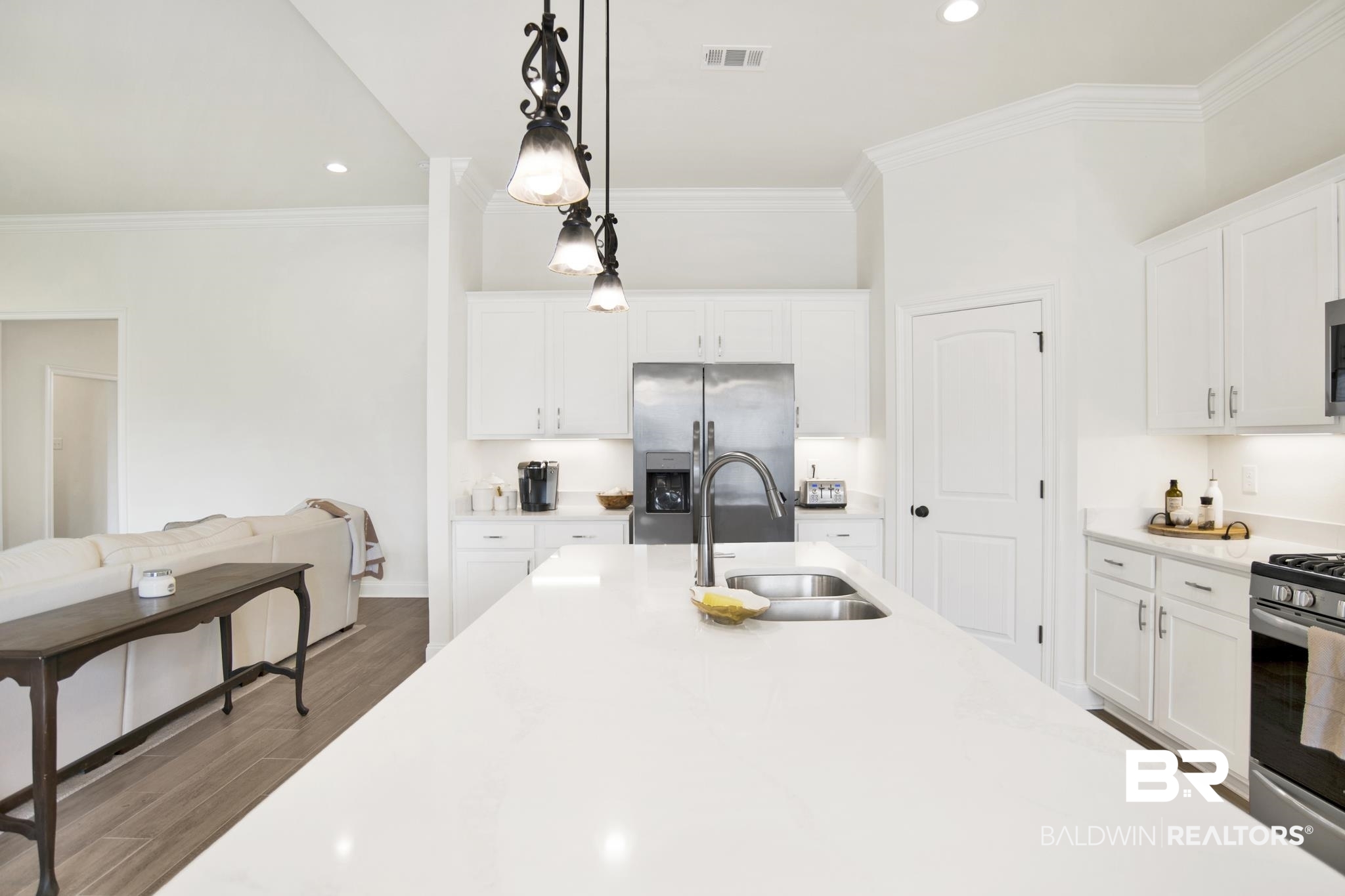 22258 Hibiscus Circle Foley, AL 36535 - Photo 6 of 26 Kitchen with wood finished floors, visible vents, ornamental molding, a sink, and appliances with stainless steel finishes