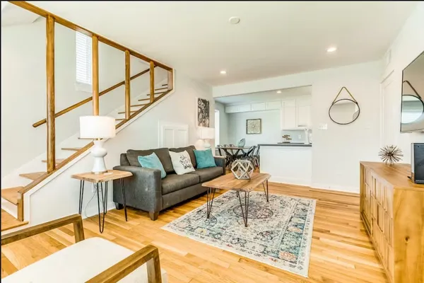 a living room with furniture and a wooden floor